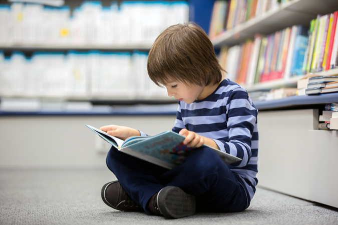 Adorable,Little,Child,,Boy,,Sitting,In,A,Book,Store,,Reading