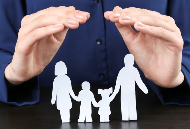Woman,Covering,Paper,Silhouette,Of,Family,With,Hands,,Closeup.,Insurance
