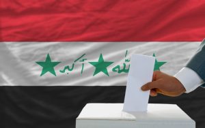 Man,Putting,Ballot,In,A,Box,During,Elections,In,Iraq