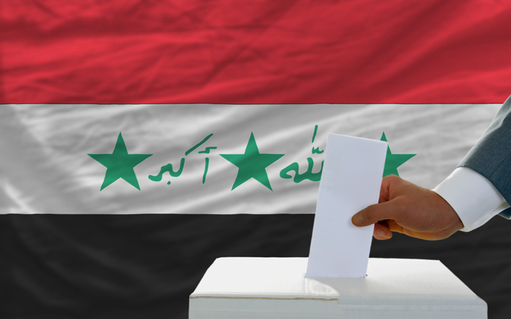 Man,Putting,Ballot,In,A,Box,During,Elections,In,Iraq