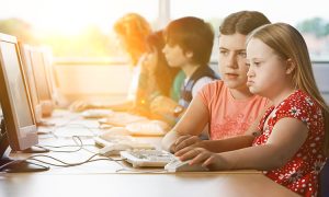 Girl,With,Down,Syndrome,Using,Computer,At,School