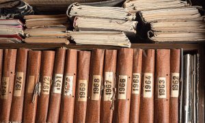 Old,Books,On,Wooden,Bookshelf.,Brown,Books,Standing,In,A