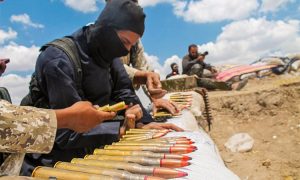 A,Soldier,In,An,Isis,Uniform,Prepares,Ammunition.,The,War