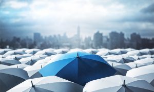 Blue,Umbrella,On,Top,Of,Other,Gray,Umbrellas,On,City