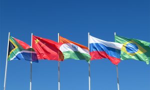 Waving,Flags,Of,The,Brics,Countries,Against,The,Blue,Sky.