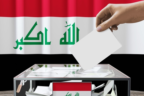 Iraq,Flag,,Hand,Dropping,Ballot,Card,Into,A,Box,-