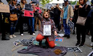 A,Woman,Cuts,Her,Hair,During,A,Demonstration,In,Front