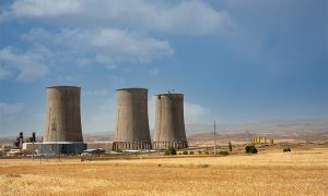 Nuclear,Power,Plant,Cooling,Towers,,Big,Chimneys,Beside,Wheat,Field