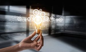 Hand,Holding,Light,Bulb,And,Cog,Inside.,Idea,And,Imagination.