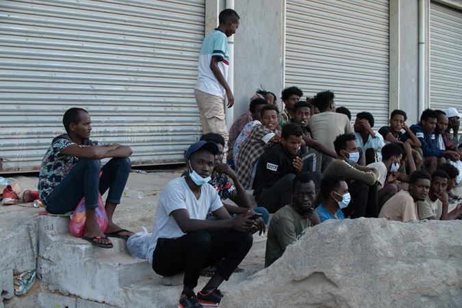 October,10,,2021:,Migrant,Women,And,Men,Wait,By,The