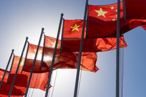 A,Row,Of,Chinese,Flags,Against,A,Blue,Sky