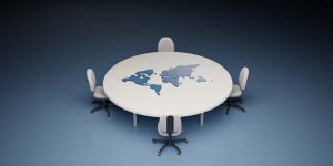 Conference table and chairs with the world map on the board. International politics concept,