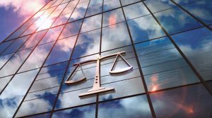 Court,With,A,Symbol,Of,Weight,On,Glass,Building.,Mirrored