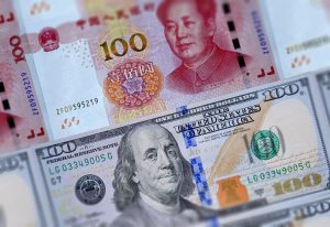 Us,100,Dollars,Bills,And,Chinese,Currency,Yuan,Banknotes,Closeup