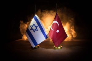 Israel,And,Turkey,Small,Flags,On,Burning,Dark,Background.,Concept