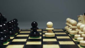 Conflict,Of,Interest.,Chess,Pieces,On,Wooden,Board.,Two,Pawns