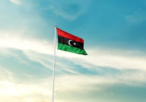 Libya,Flag,Is,Waving,On,A,Tall,Flagpole,Among,The