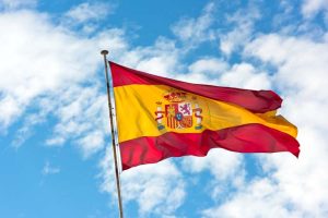 National,Flag,Of,Spain,Waving,In,The,Wind,Against,Cloudy